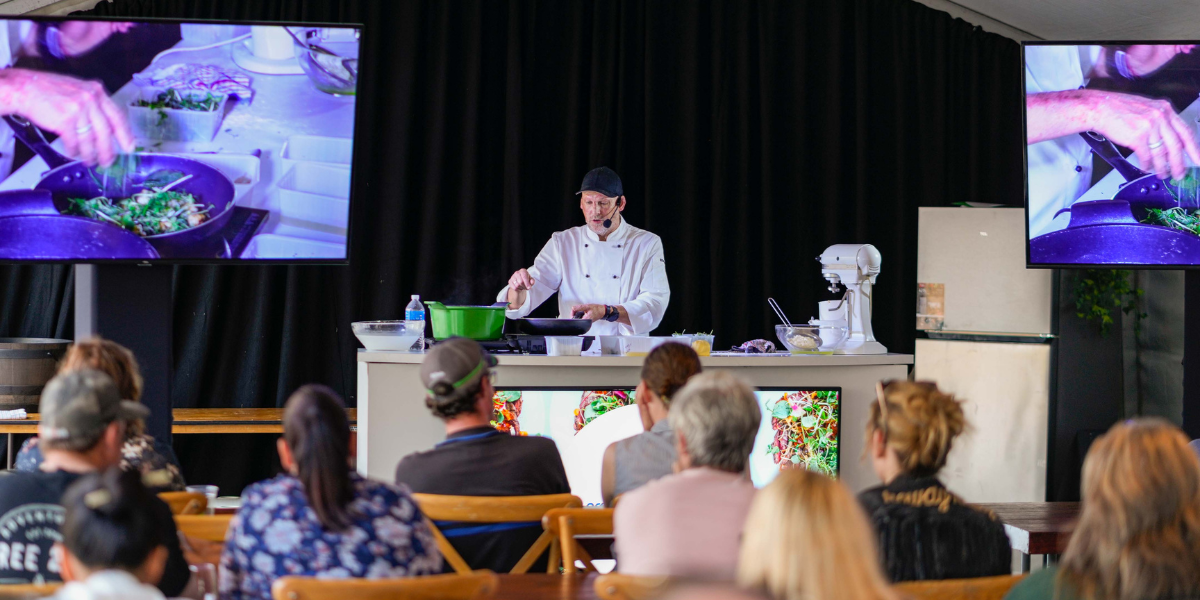 Food and wine cooking demonstration at the Capricorn Food and Wine Festival with gourmet dishes on display