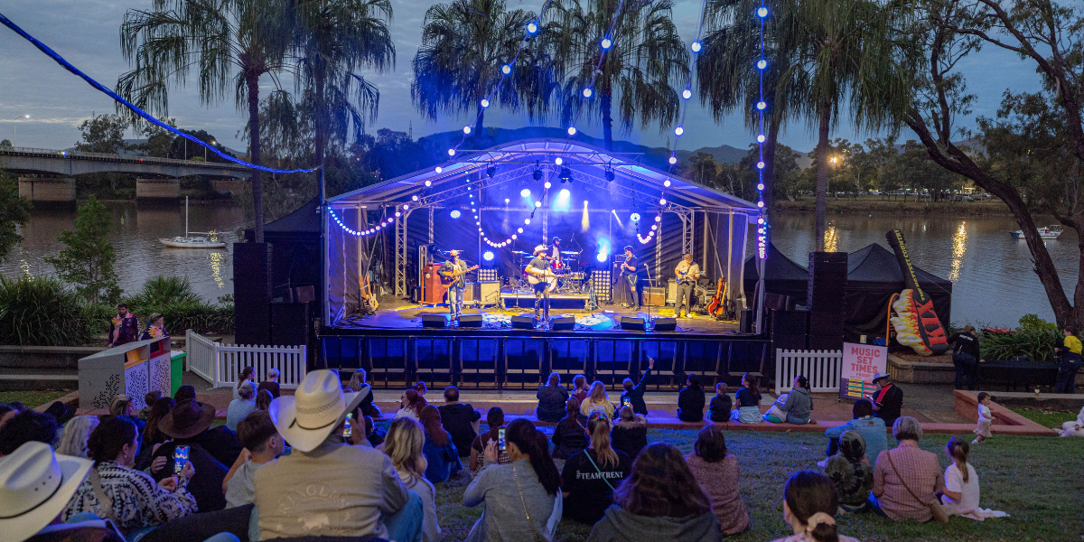 Evening scene at Rockhampton River Festival showing live performances and decorated riverfront