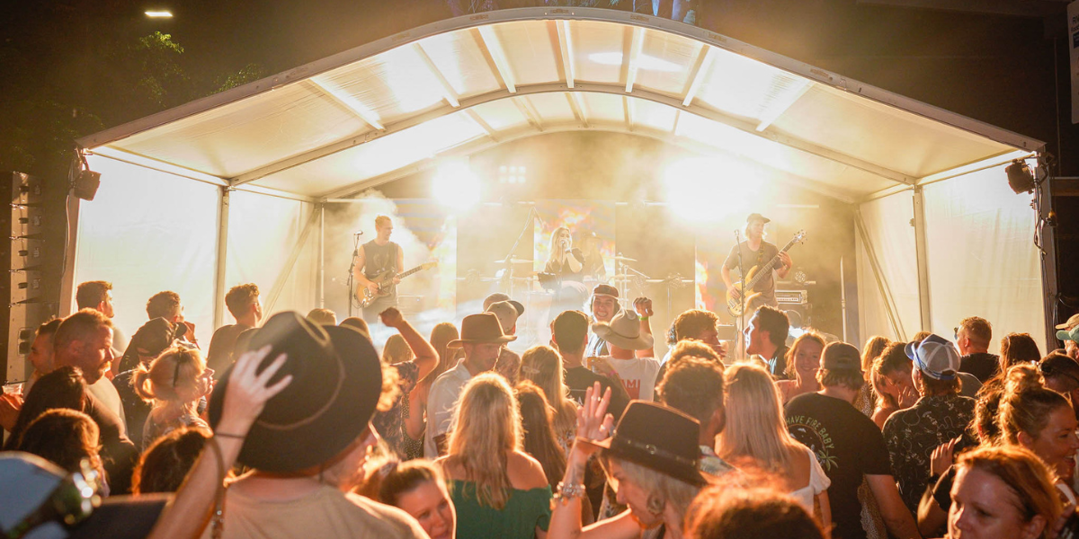 Lively crowd enjoying craft beers and live music at the Big Beer Festival.