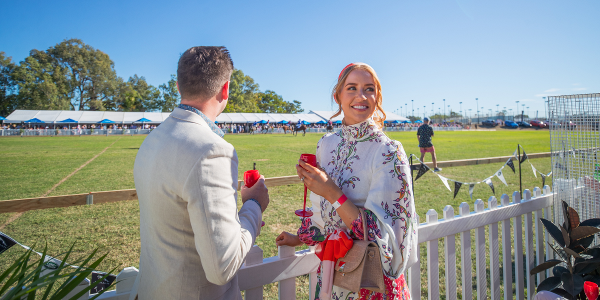 Elegant scene from Pop-Up Polo event showing spectators enjoying champagne and fashion