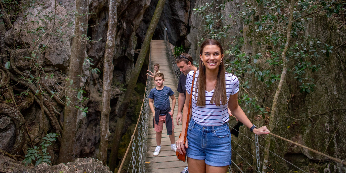 Family on the swing bridge at Capricorn Caves