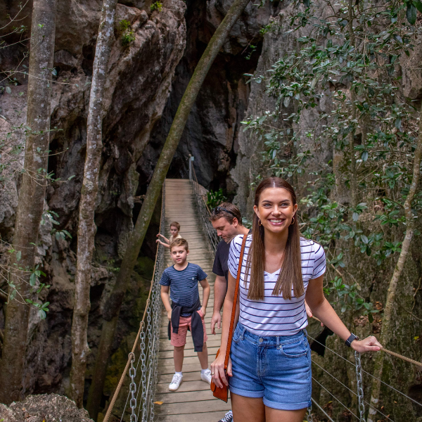 Family on the swing bridge at Capricorn Caves