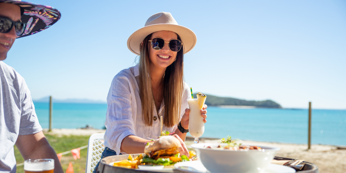 Young couple eating lunch on the beach at Great Keppel Island