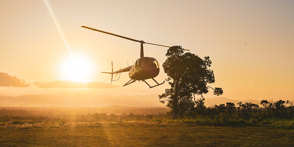 helicopter landing at sunset