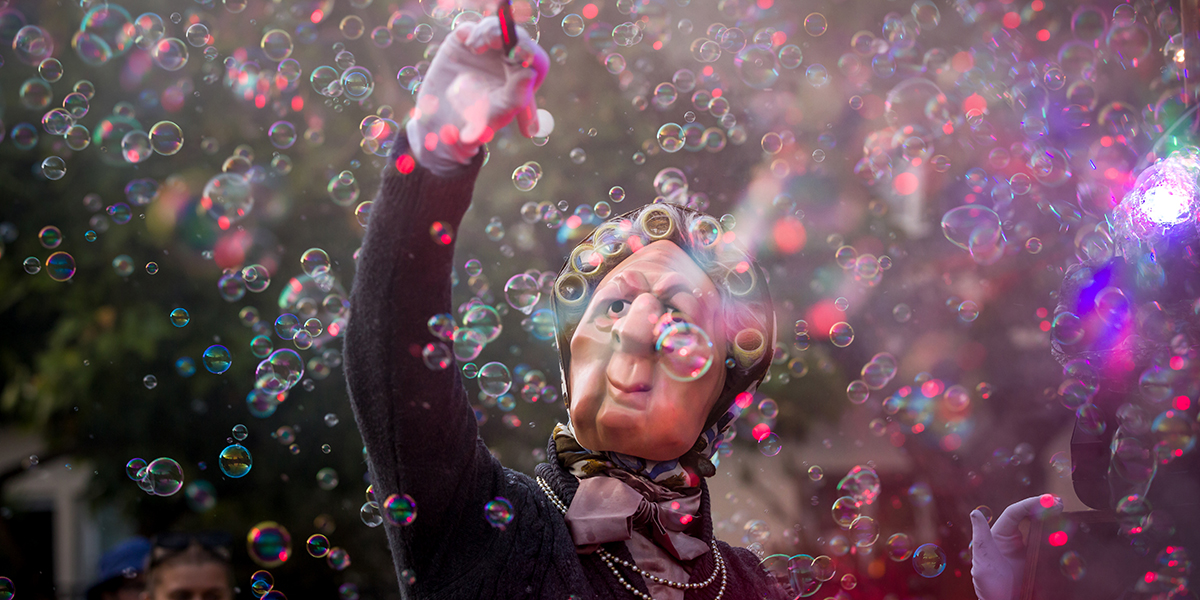 A masked person surrounded by millions of bubbles.