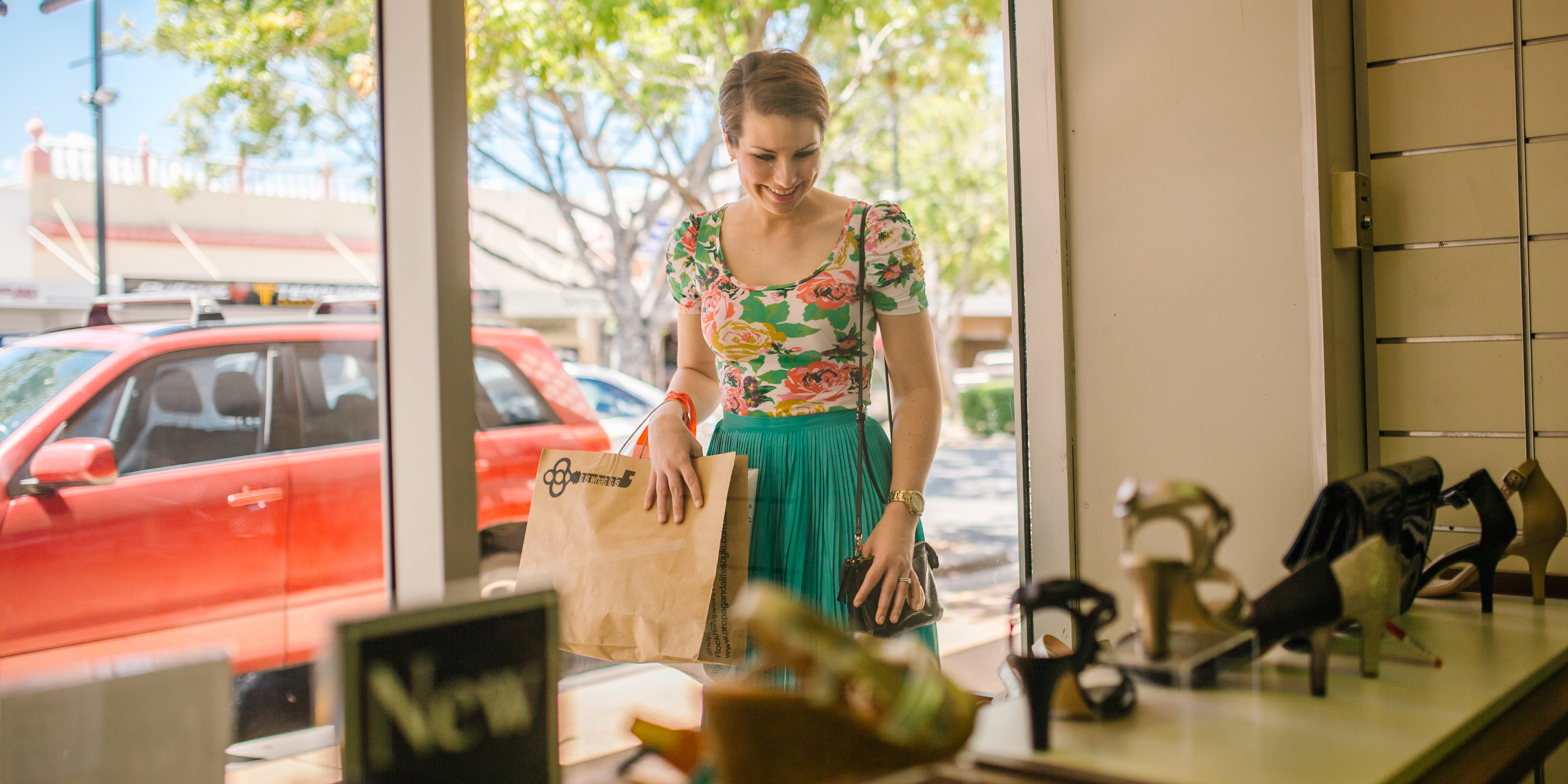 Woman smiling while she window shops for shoes