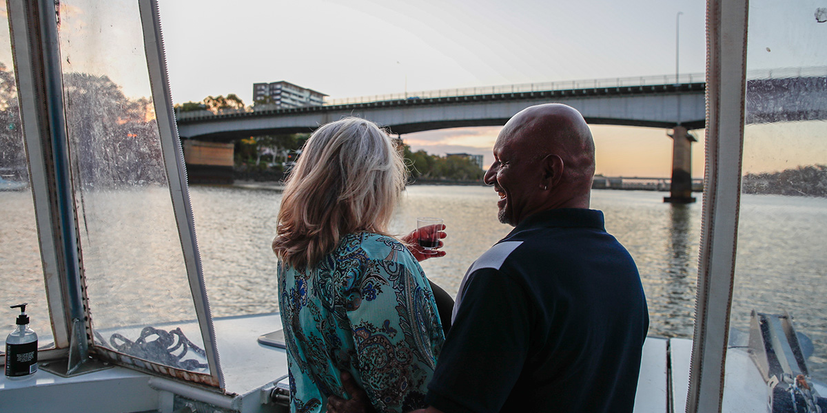 A couple sipping wine in a cruise on the river
