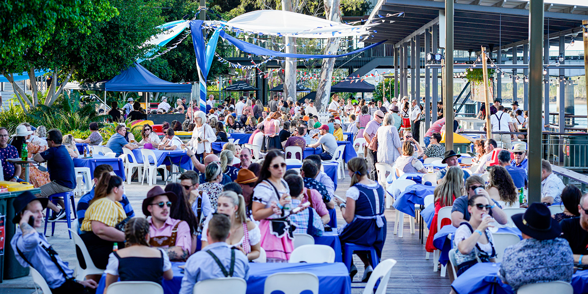 Oktoberfest crowd enjoying Bavarian beers on Rockhampton Riverside Precinct.